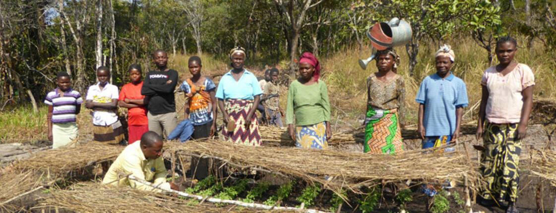 Group of people standing in a row on a field